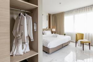 a hotel room with a bed and a room with at The 8 Hotel Udonthani in Udon Thani