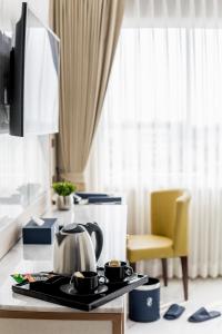 a tea kettle on a tray on a table in a room at The 8 Hotel Udonthani in Udon Thani