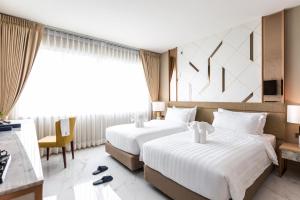 Postel nebo postele na pokoji v ubytování The 8 Hotel Udonthani