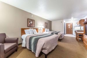 a hotel room with two beds and a bathroom at Welcome Suites-O'Fallon in O'Fallon