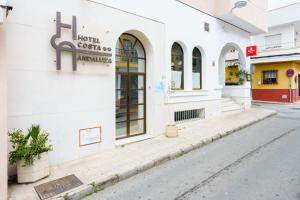 a street in front of a white building at Hotel Costa Andaluza in Motril