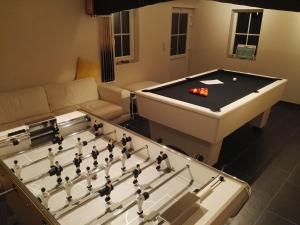 a living room with a pool table and a couch at Comfy holiday home with terrace in Ellezelles in Ellezelles