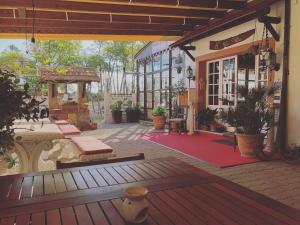 an outdoor patio with a building with a red rug at La Villa in Cervia