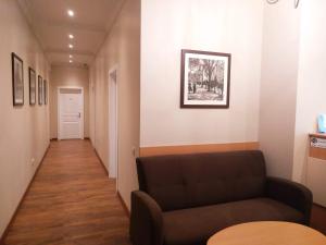 a living room with a couch and a hallway at Belokorichi in Kyiv