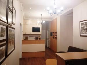 a living room with a kitchen and a dining room at Belokorichi in Kyiv