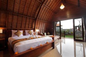 a bedroom with a large bed in a room at Pondok Naya Ubud in Ubud +79 photos