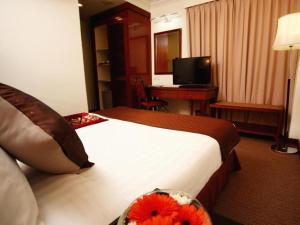 a hotel room with a bed and a desk at TH Hotel Kelana Jaya in Petaling Jaya