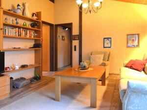 a living room with a table and a couch at Furnished Bungalow With Peaceful Neighbourhood in Meschede