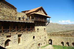 a building with people standing on a balcony at Home in Udabno in Udabno