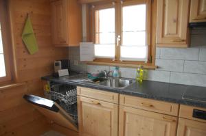 a kitchen with a sink and a counter top at Sertig Ferienwohnung in Davos +56 photos