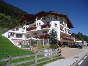 a large white building with flowers on the side of it at Hotel Andrea 3-Sterne Superior in Gerlos