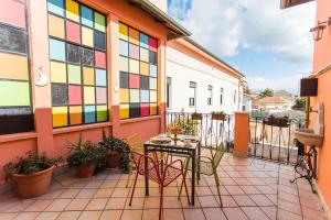 a balcony with a table and chairs and colorful windows at Garibaldi33 in Avezzano