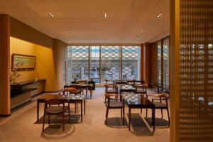 a restaurant with tables and chairs and a large window at THE KITANO HOTEL TOKYO in Tokyo