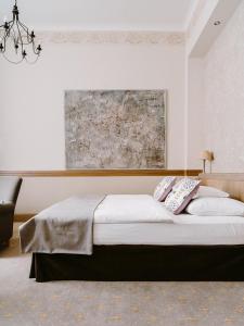 a bedroom with a bed with two pillows on it at Art Hotel in Wrocław