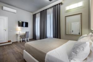 A bed or beds in a room at Blu Notte Guest House