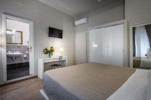 A bed or beds in a room at Blu Notte Guest House