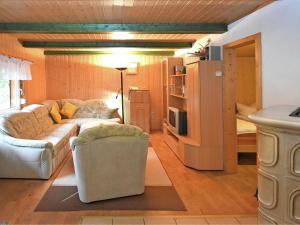 a living room with a couch and a refrigerator at Harz Home with Outdoor Space in Ilfeld