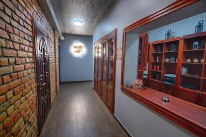 a hallway with a brick wall and wooden shelves at Hotel Tunnel of Love in Klevanʼ