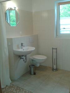 a bathroom with a sink and a toilet at Ferienwohnung Berger in Timmendorfer Strand