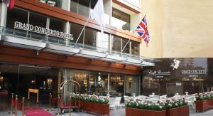 a store front of a building with pink and white flowers at Grand Concerto Hotel in Beirut