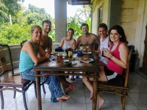 a group of people sitting around a table at Pondok Mimba in Padangbai