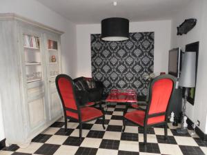 a living room with two chairs and a table at LA RENAUDIERE in Dancé