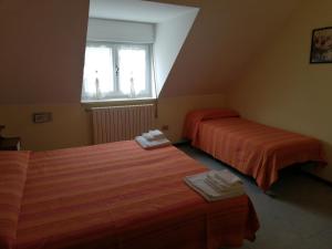 Postelja oz. postelje v sobi nastanitve Hotel Ambasciata