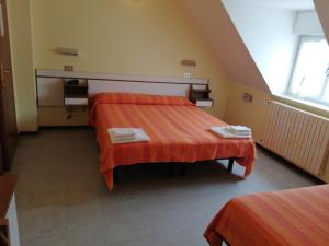 Postelja oz. postelje v sobi nastanitve Hotel Ambasciata