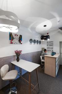 an office with a desk and a person sitting in a chair at Happy Inn in Kaunas