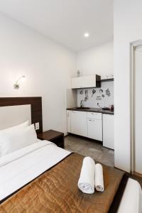 una camera da letto con un letto con due asciugamani bianchi di Happy Inn a Kaunas