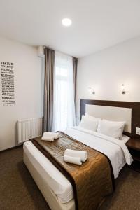 Postel nebo postele na pokoji v ubytování Happy Inn