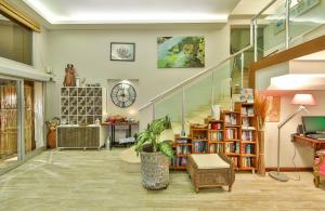 a room with a staircase and a book shelf with books at Hotel Sonne - Adults Only in Kaş