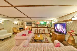 a living room with couches and a flat screen tv at Hotel Sonne - Adults Only in Kaş