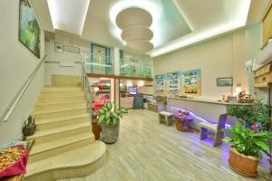 a lobby of a store with stairs and a pharmacy at Hotel Sonne - Adults Only in Kaş