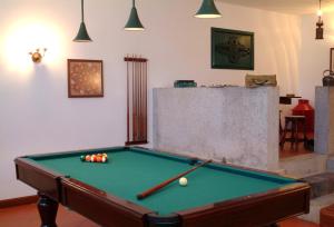 a pool table with balls in a living room at Quinta do Vale do Monte in Viana do Castelo