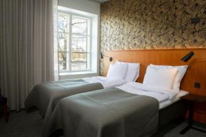 Postel nebo postele na pokoji v ubytování Hotel Lasaretti