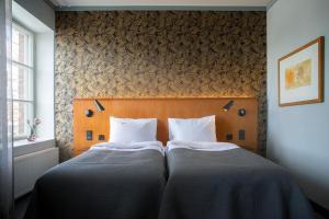 Postel nebo postele na pokoji v ubytování Hotel Lasaretti