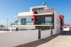 a white building with a balcony on top of it at Vitamin Sea, The Sea View Apartment in Baleal