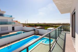 a balcony with a swimming pool on a house at Vitamin Sea, The Sea View Apartment in Baleal