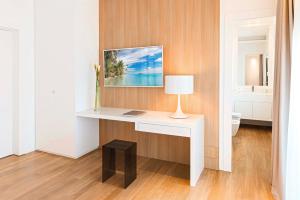 a white desk with a lamp on a wall at Dilman Luxury Stay in Bari