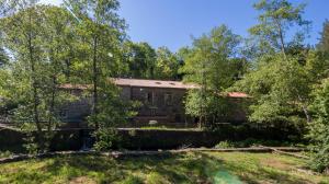 an old stone house in the woods at O Muiño de Pena in O Pino 