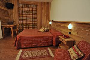 Un pat sau paturi într-o cameră la Hotel Rendez-Vous - Aymavilles