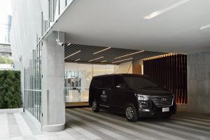 a black van parked inside of a building at Somerset Maison Asoke in Bangkok