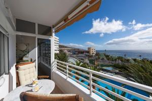 a balcony with a table and a view of the ocean at The Resthouse in Candelaria