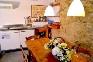 a kitchen with a wooden table with flowers on it at Brugarolas Village in Castelltersol
