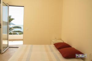 a bedroom with a bed and a view of the ocean at Apartments Boka Residence in Herceg-Novi