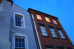 a brick building with lights in the windows at headland apartments in Hartlepool