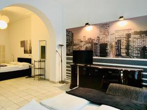 a room with a desk and a bedroom with a bed at Altstadthotel Hayk am Rhein in Cologne