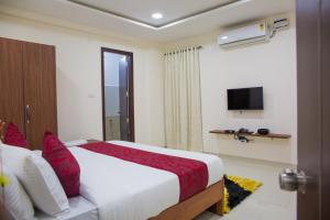 une chambre d'hôtel avec un lit et une télévision dans l'établissement Skyla Serviced Apartments Lotus Pond Jubilee Hills, à Hyderabad