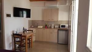 a kitchen with a table and a small kitchen with a table and chairs at ZORBAS Sea View No 1 - Antoniella in Larnaca